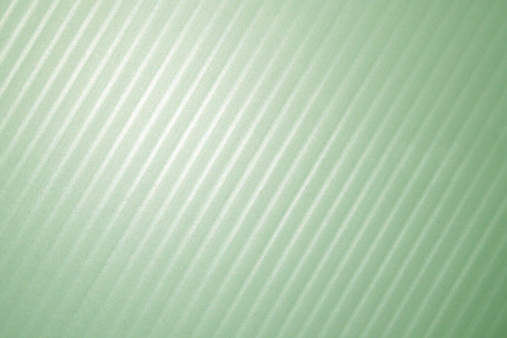 Sage green minimalist wallpaper with diagonal lines and soft light reflections for desktop background