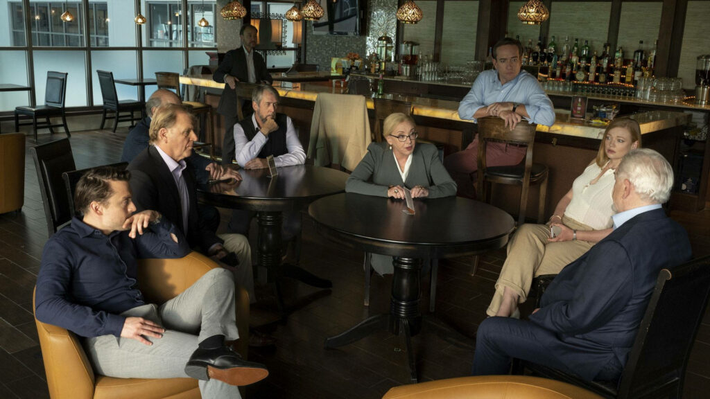 Succession Cast in Serious Meeting at Modern Bar - Wallpaper Image
