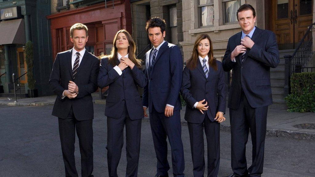How I Met Your Mother cast in sharp suits posing on urban street for stylish wallpaper background