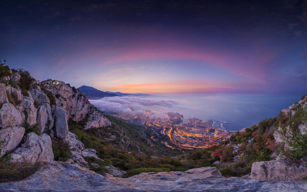 Panoramic sunrise view of Monte Carlo Monaco golden city lights mist cliffs twilight sky wallpaper