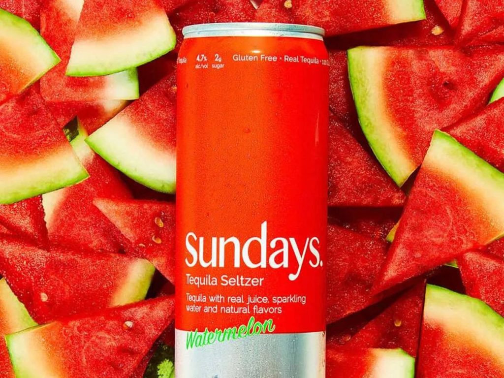 Vibrant watermelon tequila seltzer can with fresh watermelon slices summer wallpaper background