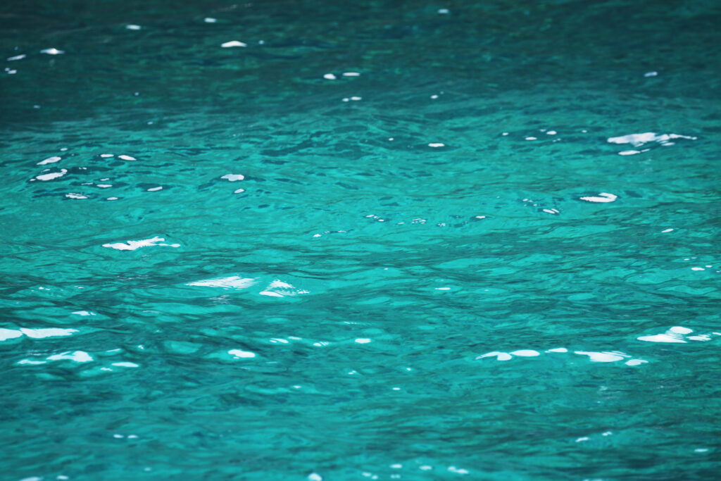 Shimmering blue water wallpaper with gentle ripples and dynamic glare in vibrant tones