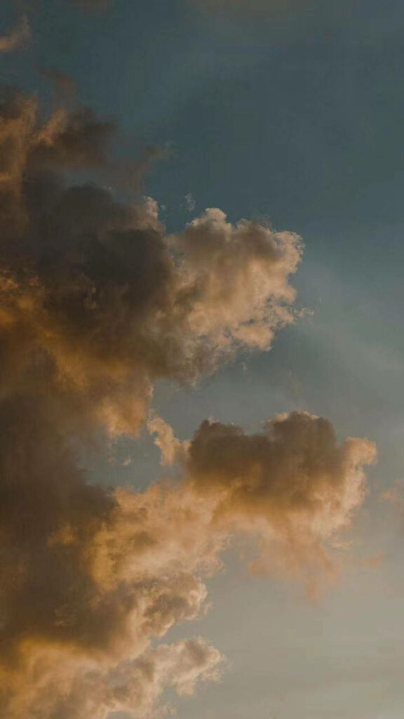Sunlit Skies: Captivating Iphone 12 Pro Background with Clouds Wallpaper