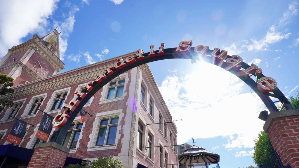 Ghirardelli Square San Francisco iconic arch and red brick clock tower under blue sky Wallpaper