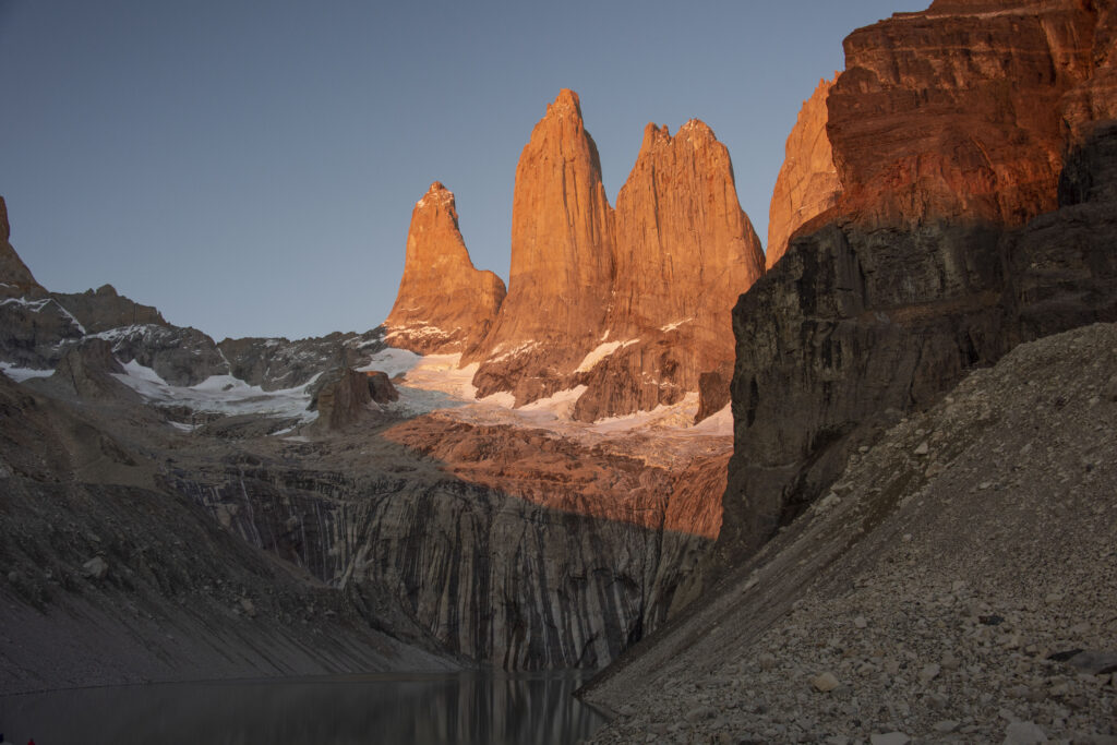 Sunlit rugged mountain peaks with dramatic rock formations and a serene natural landscape wallpaper