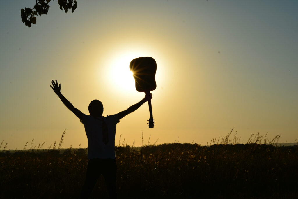 Melodic Mastery: A Musically-Inclined Man Embraces the Sunlight in 4k Wallpaper