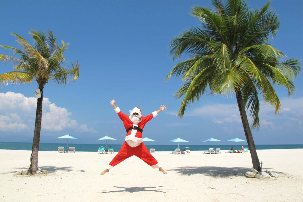 Joyful Santa on Beach: Festive Holiday Vibes with Palm Trees Wallpaper