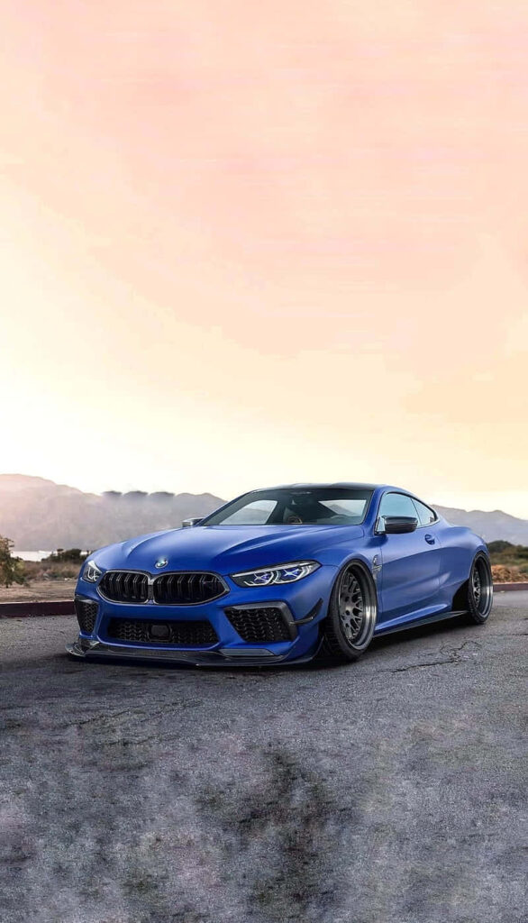 Sleek and Stunning: Sunrise Bliss with a Blue 4k BMW M8 as a Striking Wallpaper