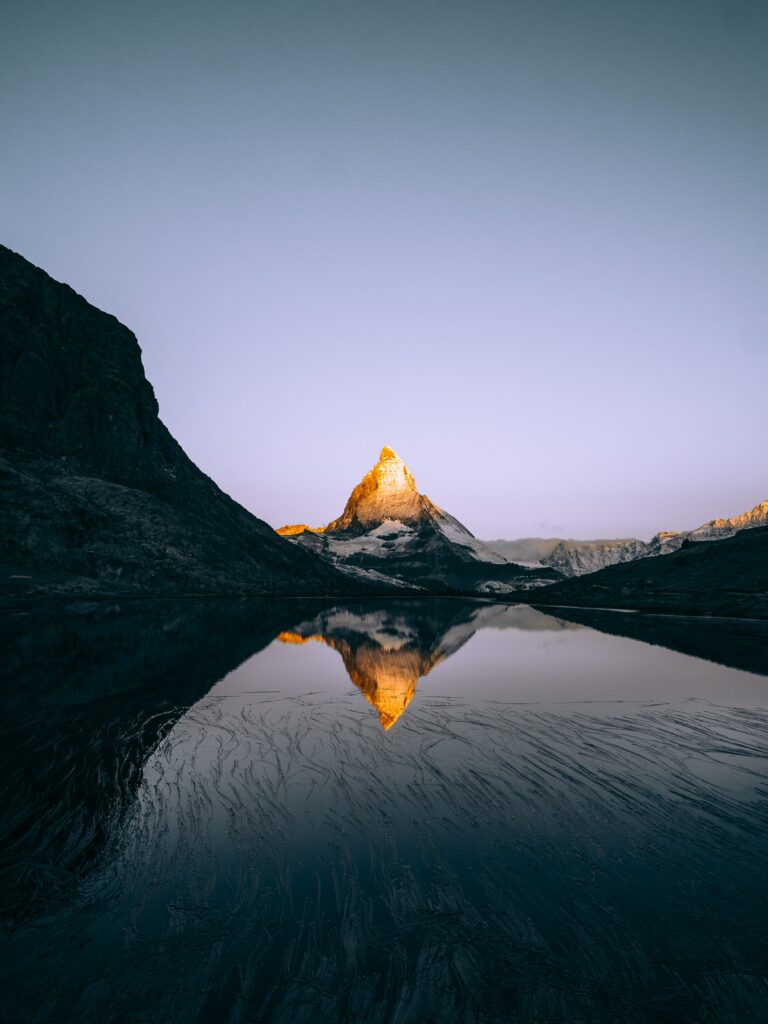 Sunrise over Matterhorn Alps reflected in Riffelsee lake peaceful Swiss mountain landscape wallpaper