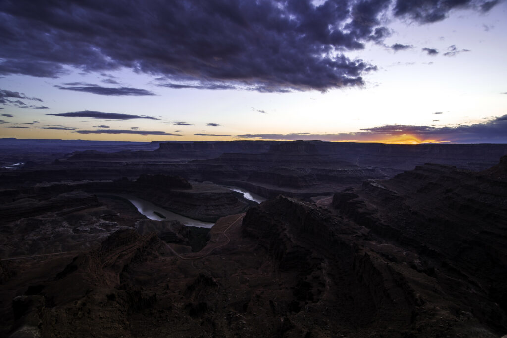 Vibrant sunset canyon wallpaper with rugged cliffs and winding river in deep valleys landscape
