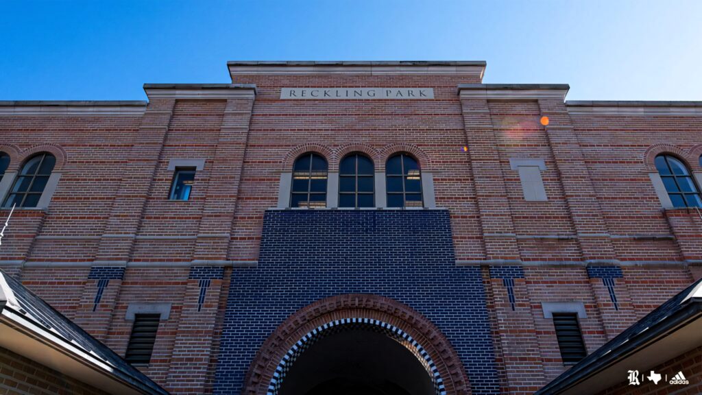 Sunset glow on Reckling Park brick facade at Rice University with clear blue sky background Wallpaper