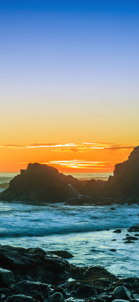 Serene Sunset over Malibu's Majestic Ocean Stacks Wallpaper