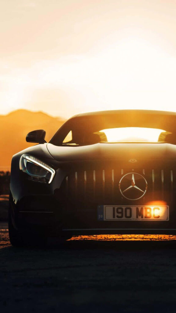 Sunset Horizon Embraces a Classy Mercedes Benz Saloon Car as a Captivating Mercedes Benz Phone Background Wallpaper