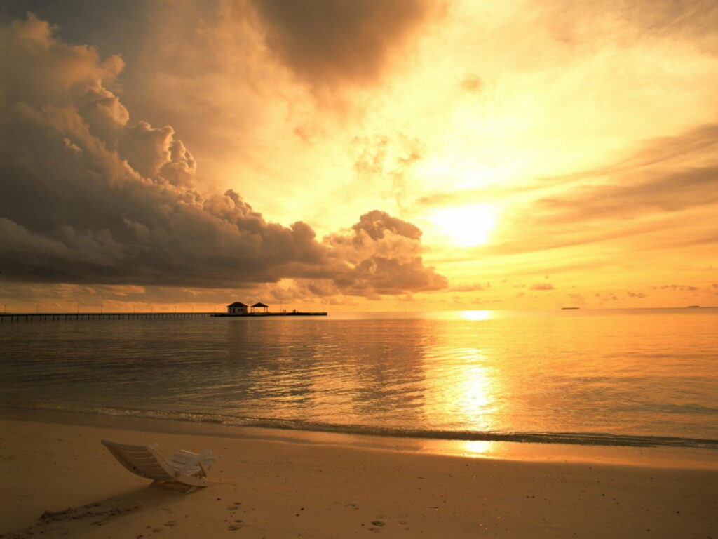 Seaside Serenity: A Captivating Sunset on the Ocean Deck Wallpaper