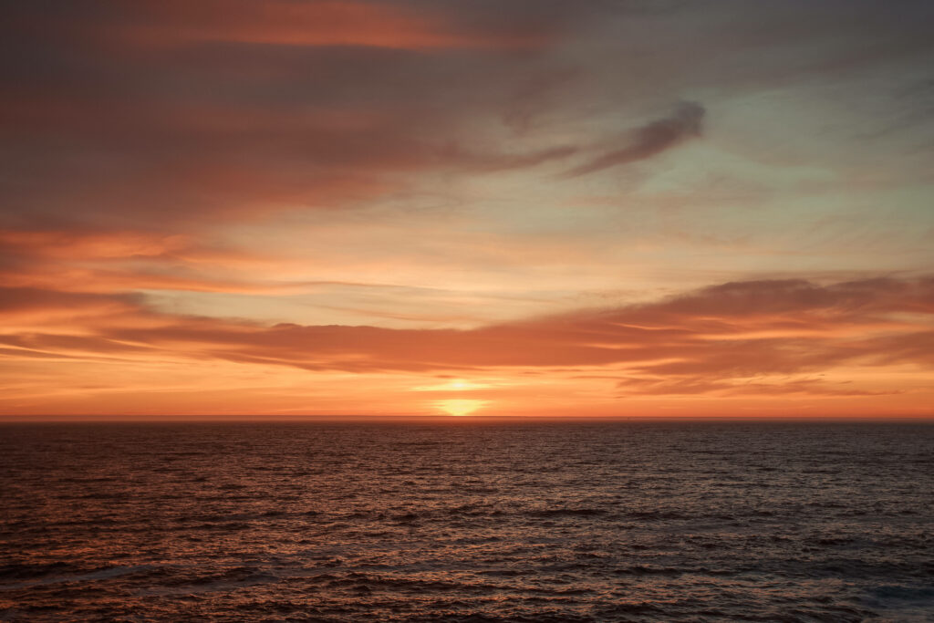 Oceanic Sunset Bliss: Captivating Wide-Angle Shot of a Fiery Orange Horizon in Mesmerizing Ocean Desktop Background Wallpaper