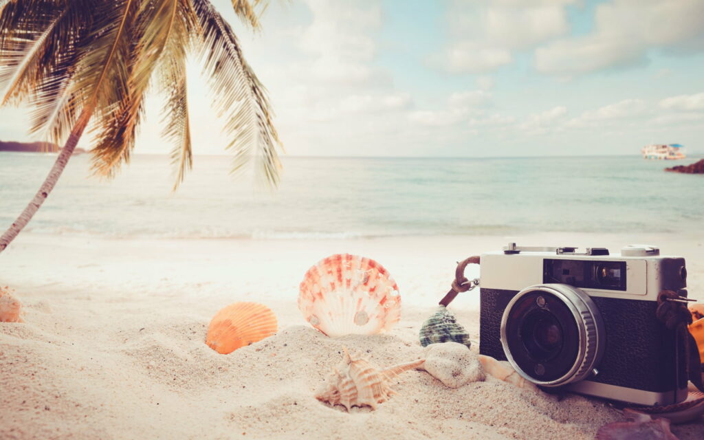 Sunset Serenity: Capturing the Essence of Summer Travels with Beach Accessories and Seashells Wallpaper