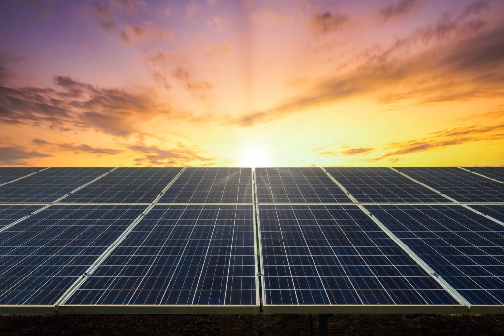 Sunset over solar panels in a colorful field embracing sustainable energy landscape wallpaper