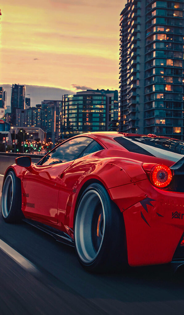 Revving Passion: Captivating Sunset Drive on Urban Streets - Rear View of Flamboyant Red Ferrari 458 Wallpaper