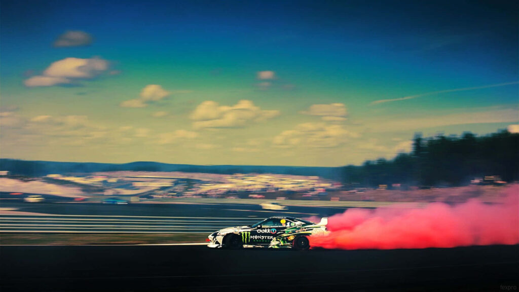 Supra drift car racing with vibrant pink smoke trail under clear blue sky motorsport wallpaper