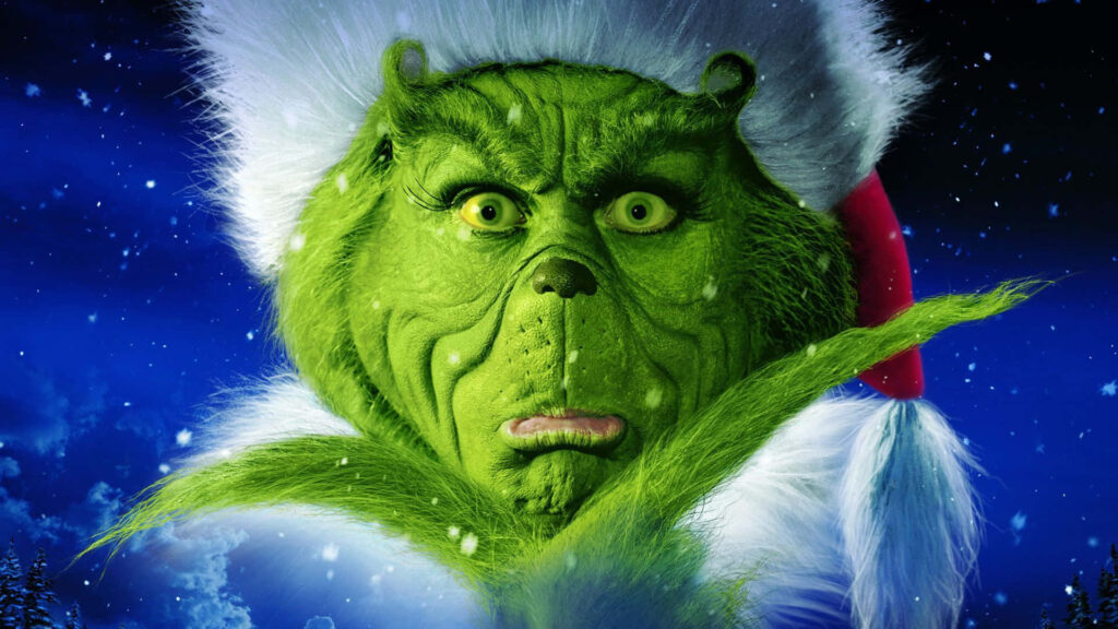 Shocked Grinch in Santa Outfit Against Snowy Night Background Wallpaper