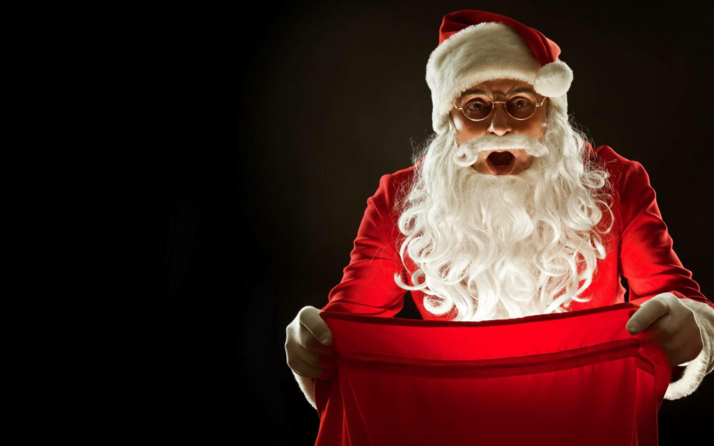 Surprised Santa Claus Wallpaper: Festive Red Bag on Dark Background