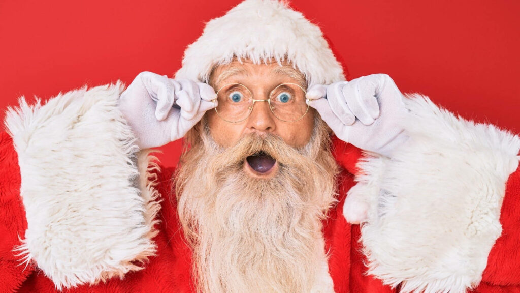 Surprised Santa Claus Wallpaper on Bright Red Christmas Background