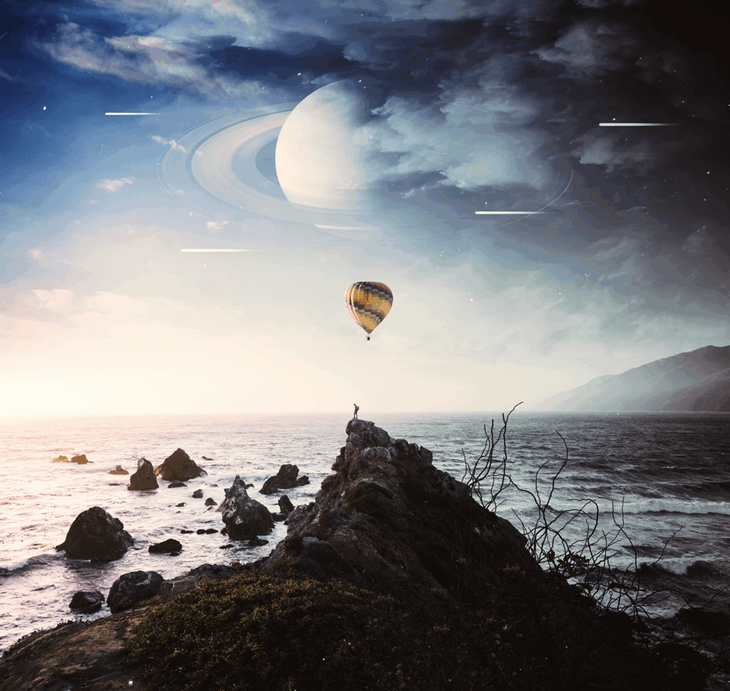 Vibrant air balloon over rocky coastline sunset with silhouetted figure and surreal ringed planet Wallpaper