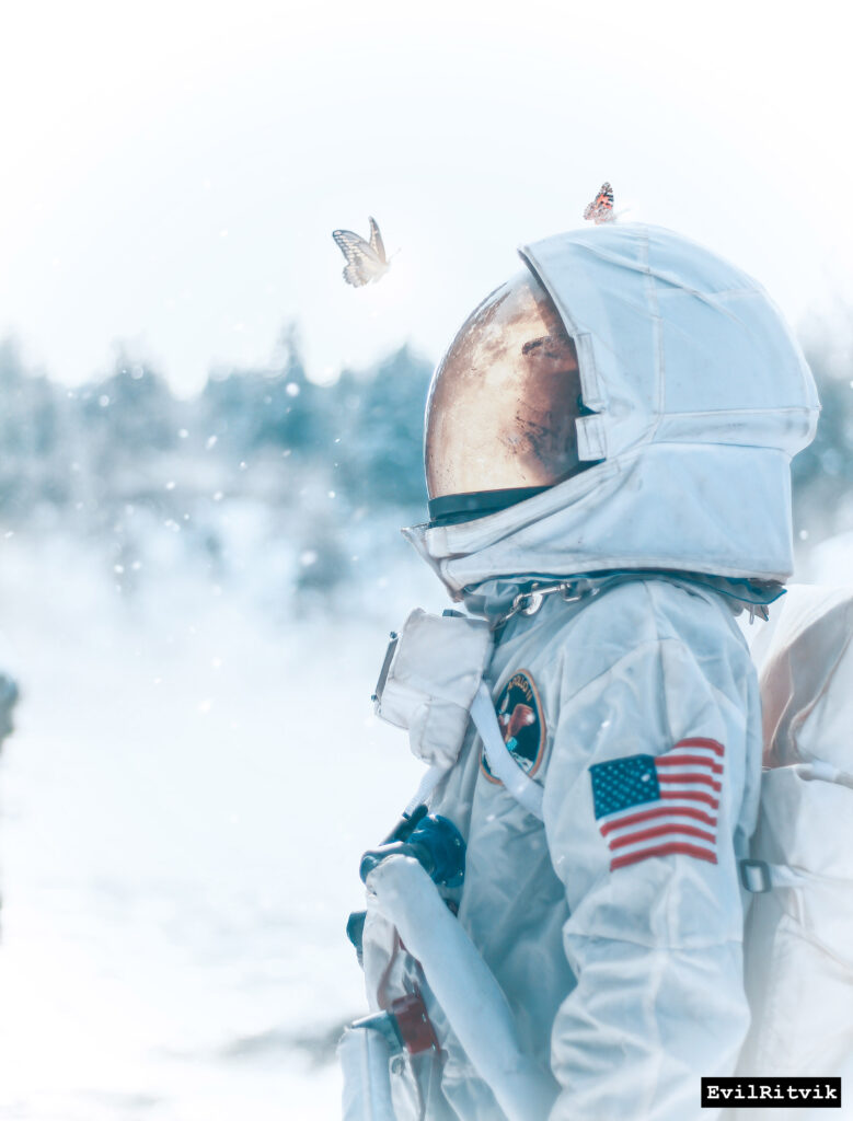 Dreamy Astronaut Wallpaper: Surreal Snowy Landscape with Butterfly