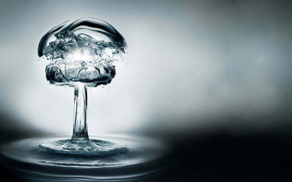 High-speed photo of a water splash forming a liquid mushroom cloud on cool minimalist background Wallpaper