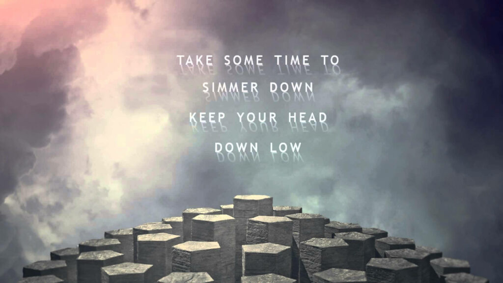 Surreal wallpaper with hexagonal stone pillars in mist and glowing Imagine Dragons Tip Toe lyrics