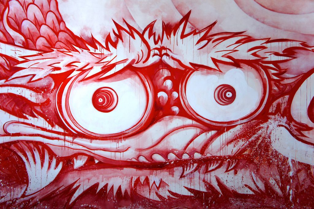 Surreal monster face wallpaper in red and white Superflat style with intense eyes and dripping textures