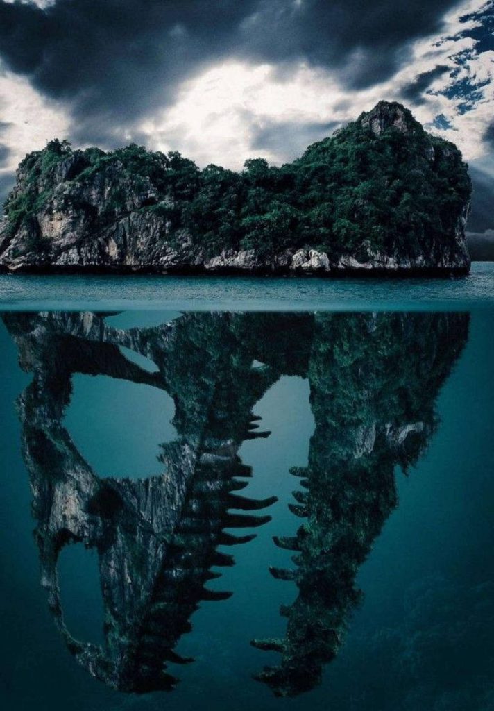 Surreal tropical island transforming into dinosaur skull underwater with moody ocean tones background Wallpaper