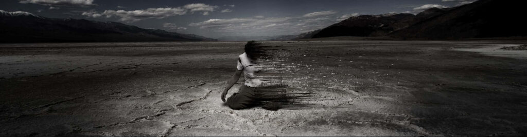 Surreal Landscape Wallpaper: Person Dissolving in Mystical Setting