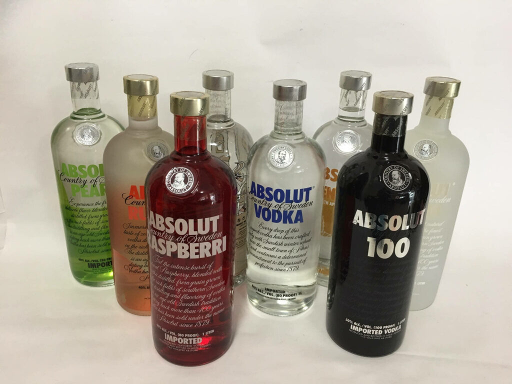 Swedish Absolut Vodka bottles collection with various flavors and limited editions on display Wallpaper