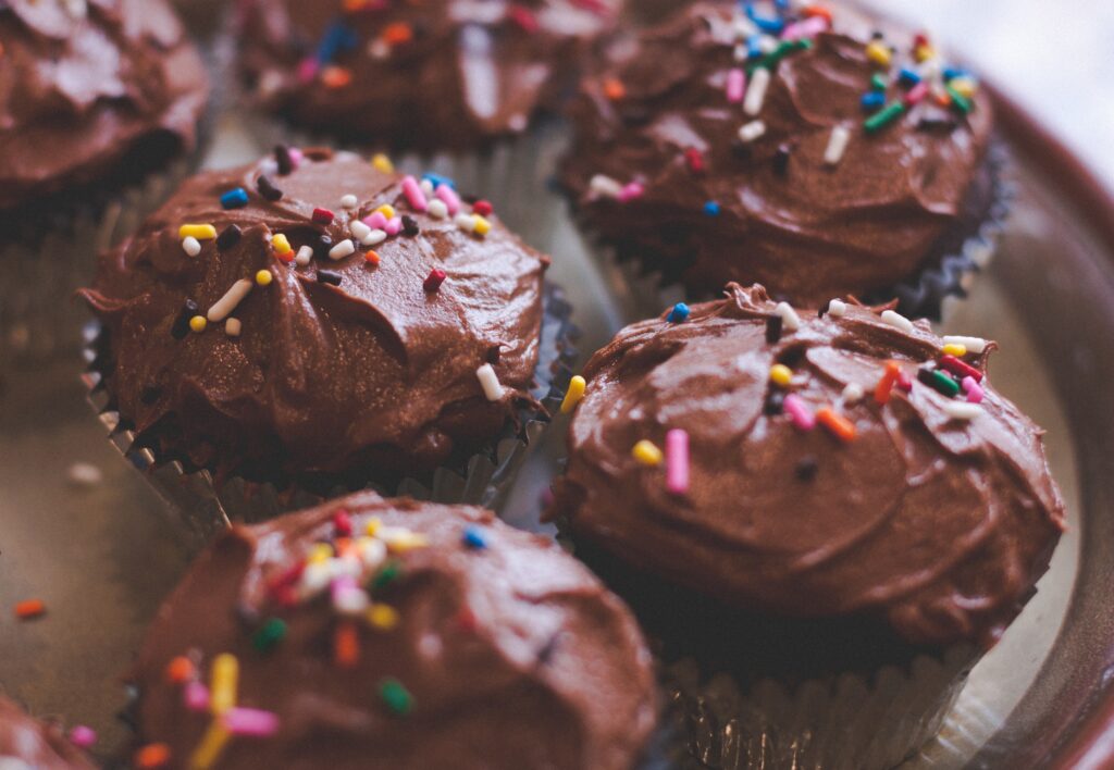 Festive Chocolate Cupcake Wallpaper with Creamy Frosting & Sprinkles