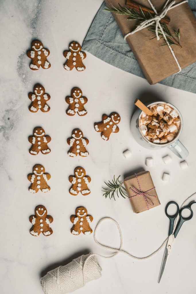 Festive Delights: Smiling Gingerbread Cookies and Scrumptious Hot Chocolate Blend Wallpaper