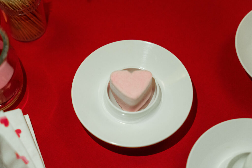 Sweet Love Delights: Captivating Valentine's Day Treat in Mini Pink Heart Cake on a Serene Background Wallpaper