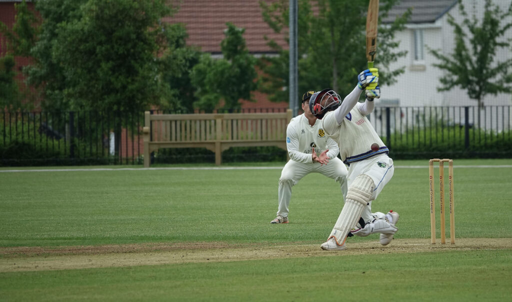 Missed Opportunity: Cricket Player's Dynamic Swing in Vibrant Action Shot Wallpaper