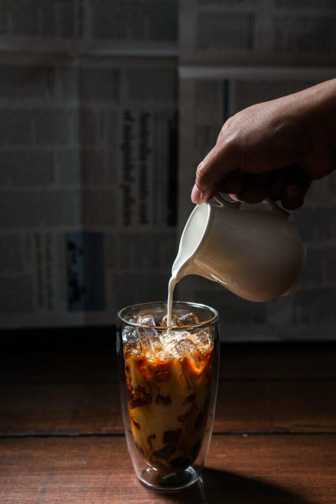 Swirling Milk Pour in Iced Coffee: Stylish Wallpaper Background