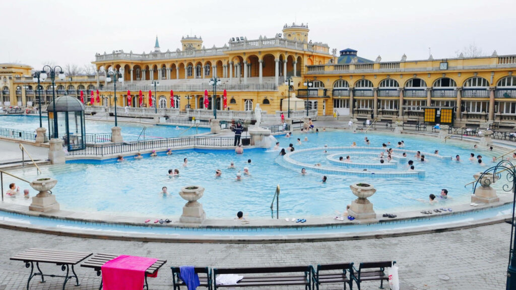 Széchenyi Thermal Bath Budapest outdoor pool with historic architecture and people enjoying waters Wallpaper