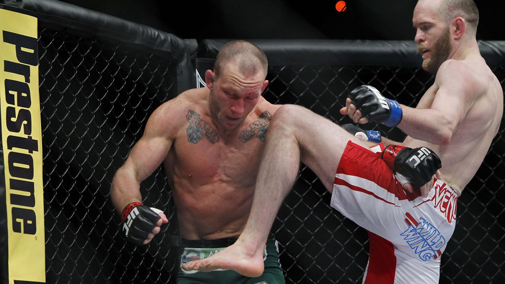 T.J. Grant lands powerful knee on Gray Maynard UFC 160 intense MMA octagon fight action wallpaper