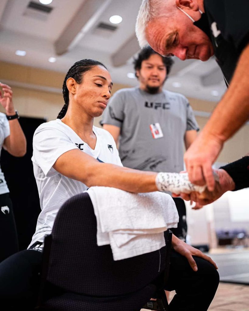 MMA fighter Taila Santos hands wrapped by coach focused before UFC fight training wallpaper