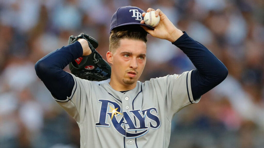 Blake Snell tired on mound adjusting cap in Tampa Bay Rays uniform during baseball game wallpaper
