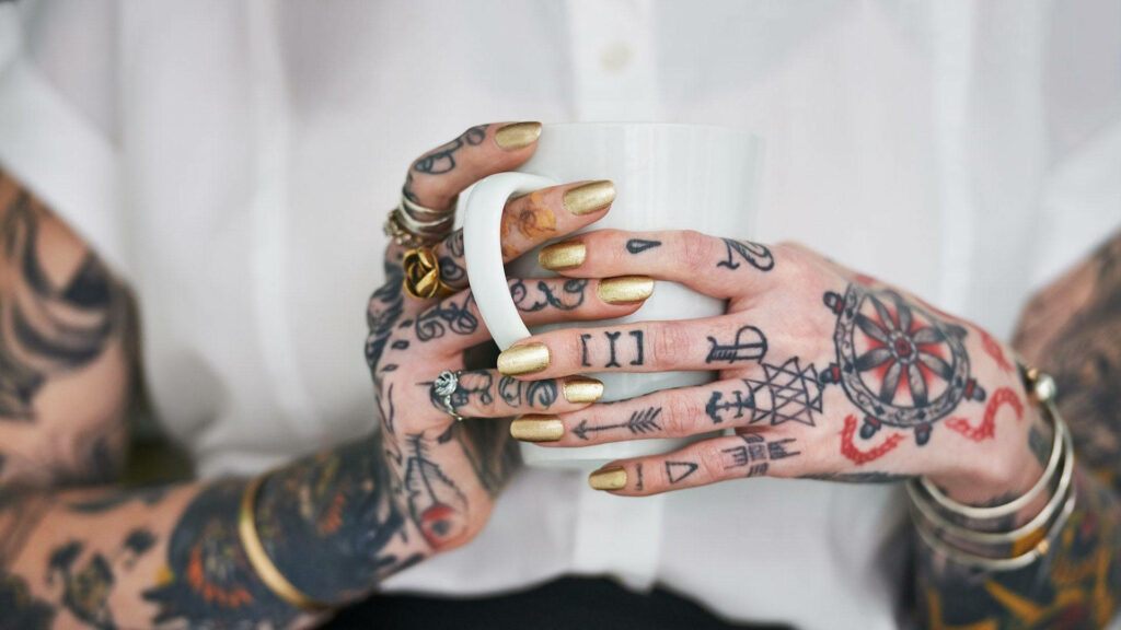 Inked Elegance: Dainty Tattooed Hands Wallpaper