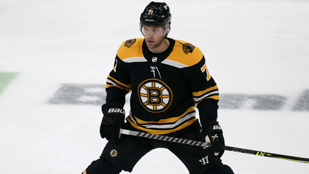 Taylor Hall Boston Bruins in black gold jersey intense focus dynamic hockey action wallpaper