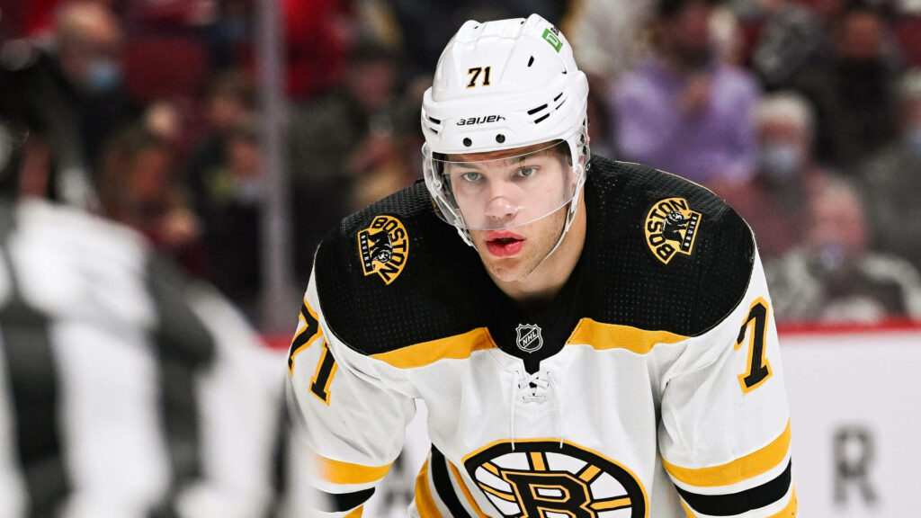Taylor Hall in white Boston Bruins uniform intense NHL hockey action dynamic sports wallpaper