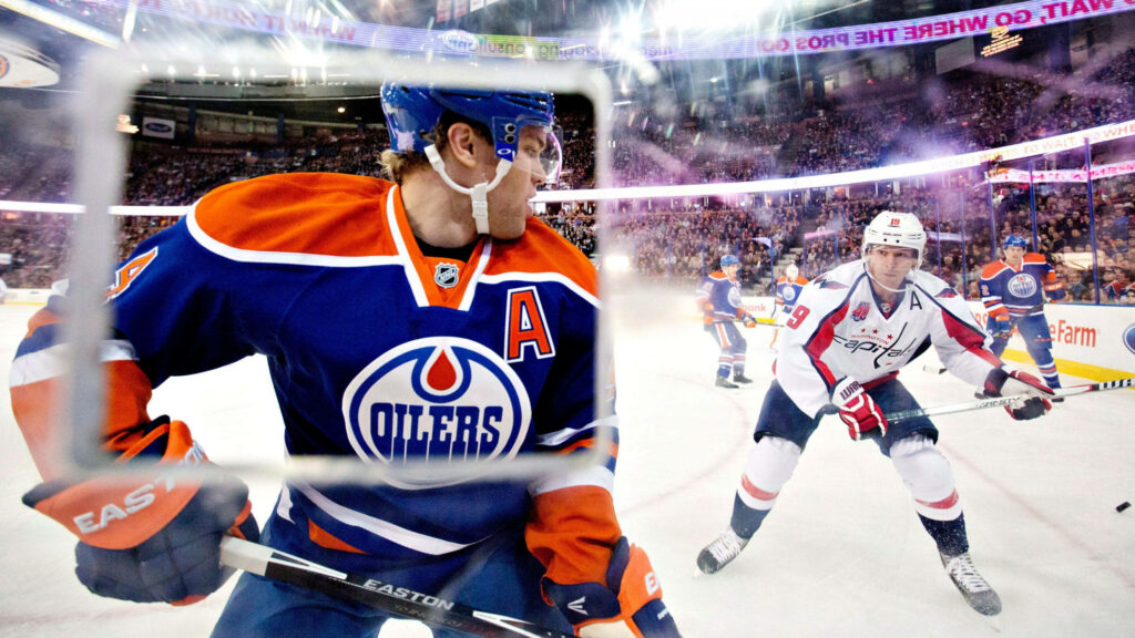 Taylor Hall in Edmonton Oilers jersey skating fast during intense NHL hockey game action wallpaper