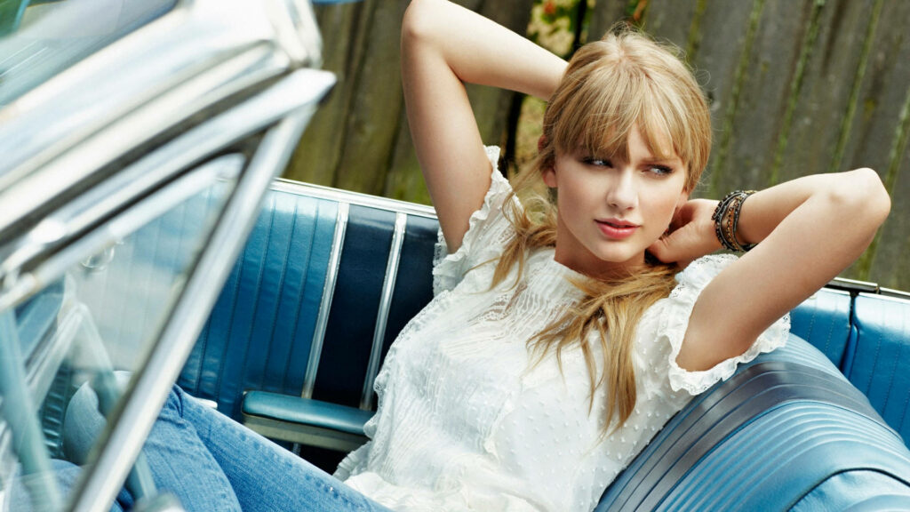 Taylor Swift relaxing in classic car backseat vibrant wallpaper stylish calm music icon background