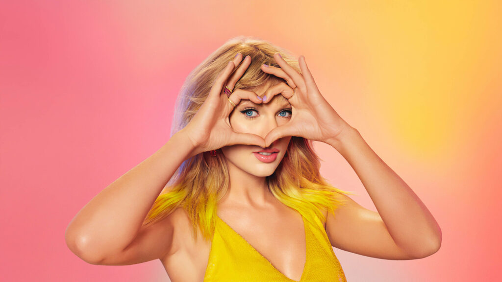 Taylor Swift smiling forming heart hands colorful vibrant background positive wallpaper