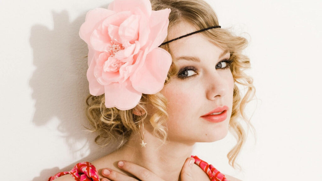 Taylor Swift in pink flower headpiece with soft expression and delicate curls Seventeen Magazine Wallpaper
